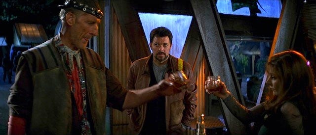 Characters Cochrane, Riker, and Troi collaborating