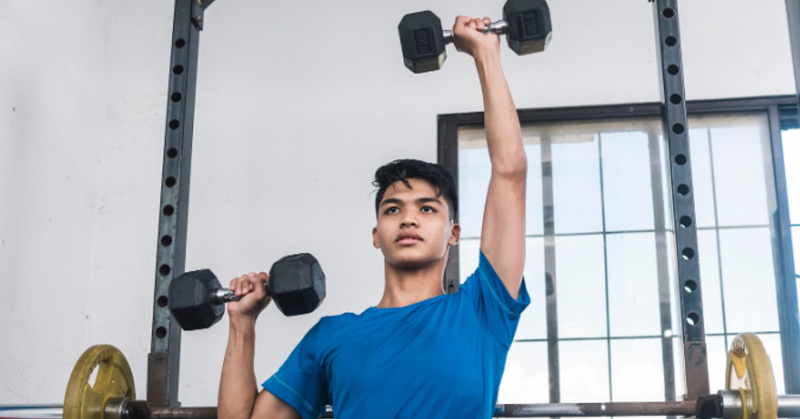 Child performing an alternating shoulder press