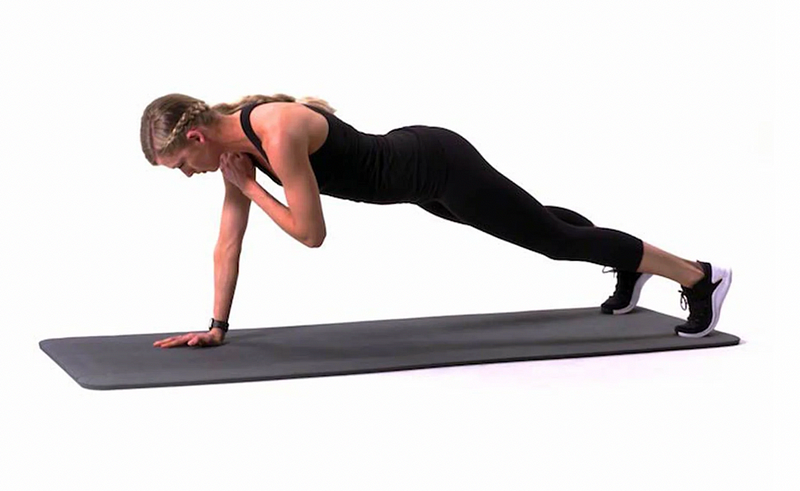 Child performing a shoulder tap plank