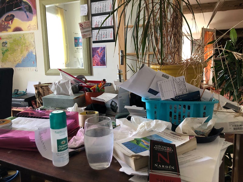 A cluttered desk reflecting a chaotic mind